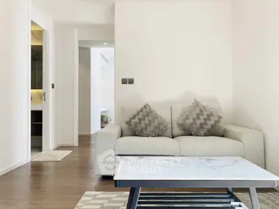 Modern living room with cozy sofa and stylish coffee table in bright apartment.
