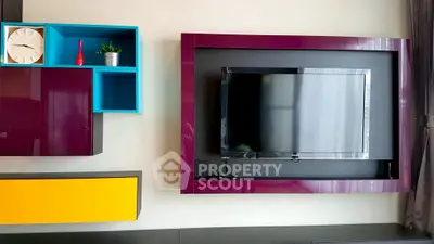 Modern living room with stylish TV wall unit and colorful shelves
