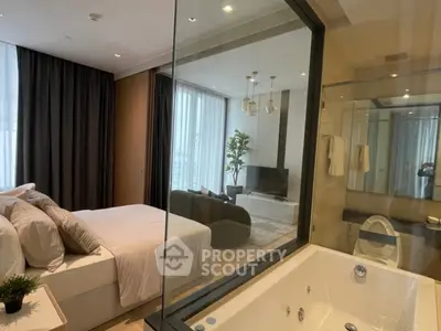 Luxurious bedroom with ensuite bathroom featuring a modern bathtub and stylish decor.