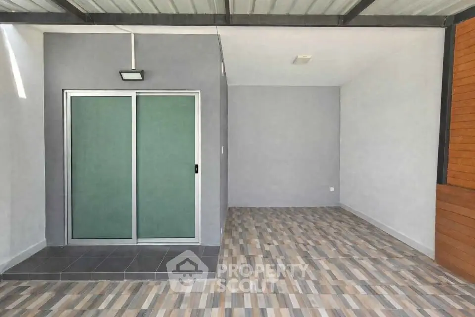 Modern covered patio with tiled flooring and sliding glass doors
