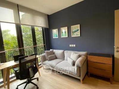 Chic living room with modern decor and lush garden view, perfect for relaxation and productivity.