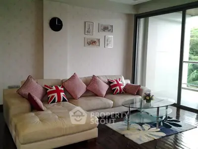 Stylish living room with modern decor and large glass doors leading to a balcony.