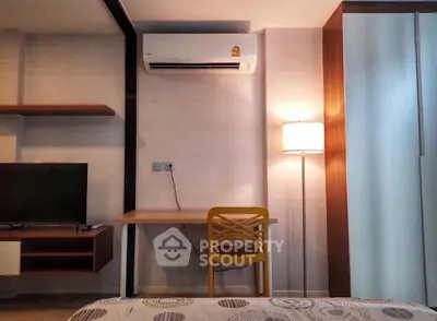 Modern bedroom with air conditioning, stylish furniture, and cozy lighting