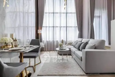 Luxurious modern living room with high ceilings, elegant decor, and abundant natural light.