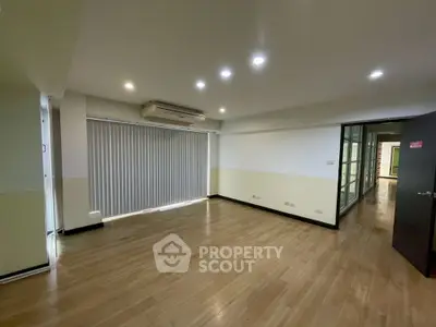 Spacious modern living room with wooden flooring and recessed lighting
