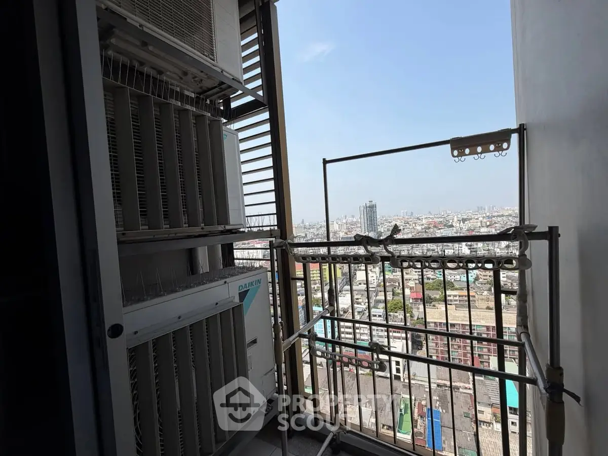 High-rise balcony with cityscape view and air conditioning units