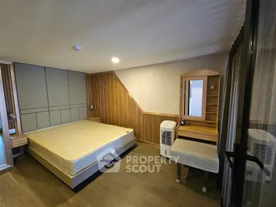 Spacious modern bedroom with stylish wood paneling and elegant furnishings