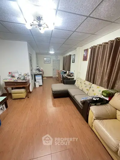 Spacious living room with cozy seating and elegant lighting