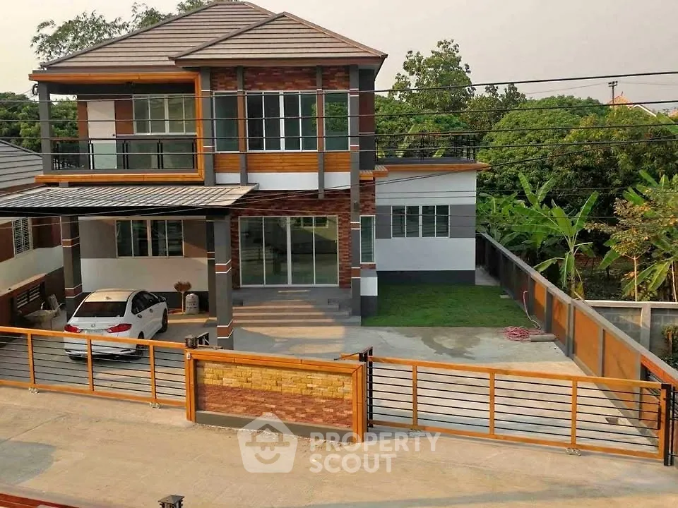 Modern two-story house with carport and lush garden in suburban setting.