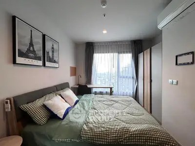 Cozy bedroom with city view, modern decor, and ample natural light
