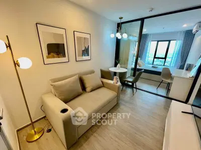 Modern living room with cozy sofa and stylish decor in open-plan apartment