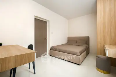 Modern minimalist bedroom with sleek furniture and neutral tones