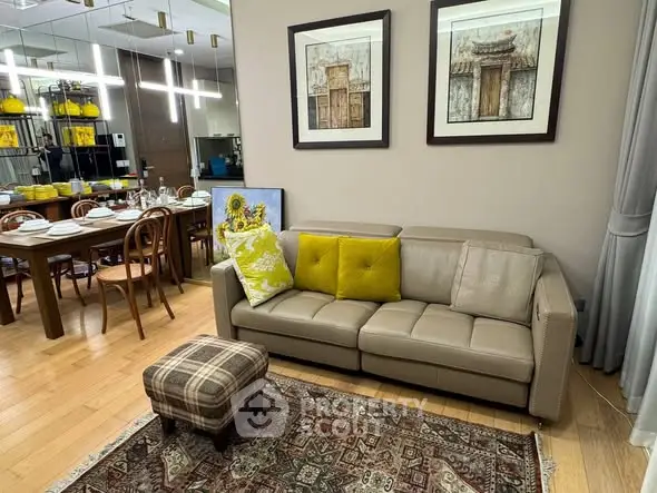 Stylish living room with elegant dining area, featuring modern decor and cozy seating.