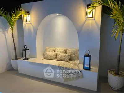 Elegant modern seating nook with ambient lighting and decorative pillows, perfect for stylish relaxation.
