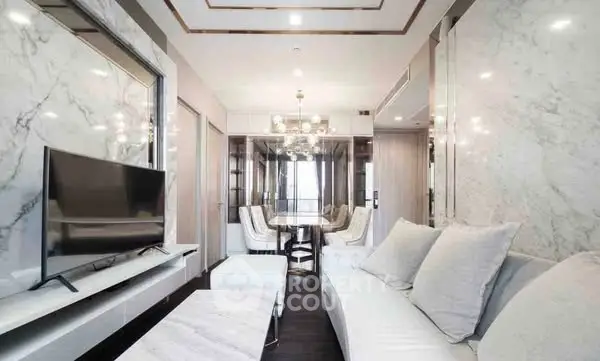 Luxurious modern living room with marble accents and elegant dining area.