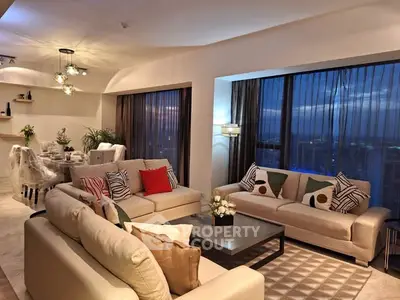 Luxurious modern living room with elegant decor and city view at dusk.