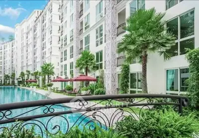 Luxurious condominium with poolside view and lush greenery