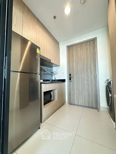 Modern kitchen with stainless steel appliances and sleek wooden cabinetry