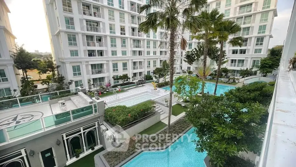 Luxurious apartment complex with stunning pool and lush greenery