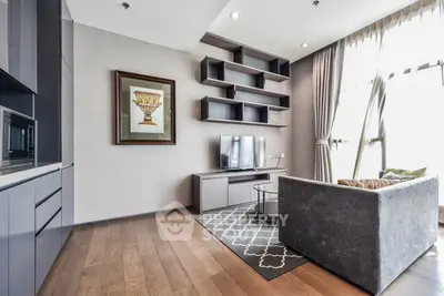 Modern living room with sleek furniture and large windows offering natural light.