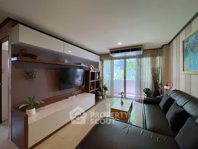 Modern living room with sleek furniture and large window offering a serene view of greenery.