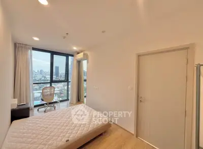 Modern bedroom with city view, featuring a large window and minimalist decor.