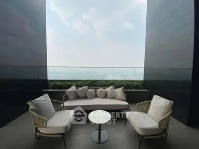 Luxurious balcony with stunning city view and stylish seating area