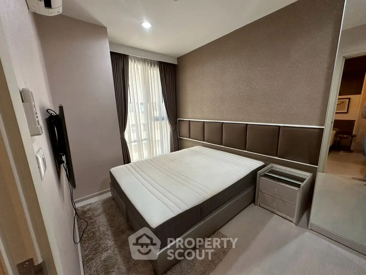 Modern bedroom with sleek design and large window for natural light