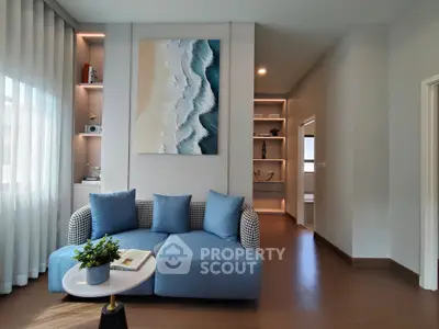 Modern living room with stylish blue sofa and elegant wall art