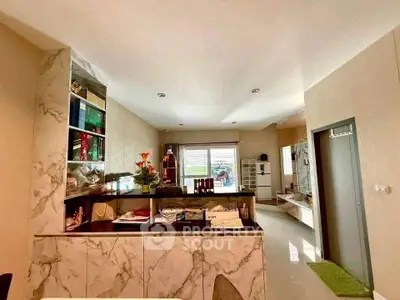 Modern kitchen with marble accents and open layout, featuring sleek cabinetry and ample natural light.