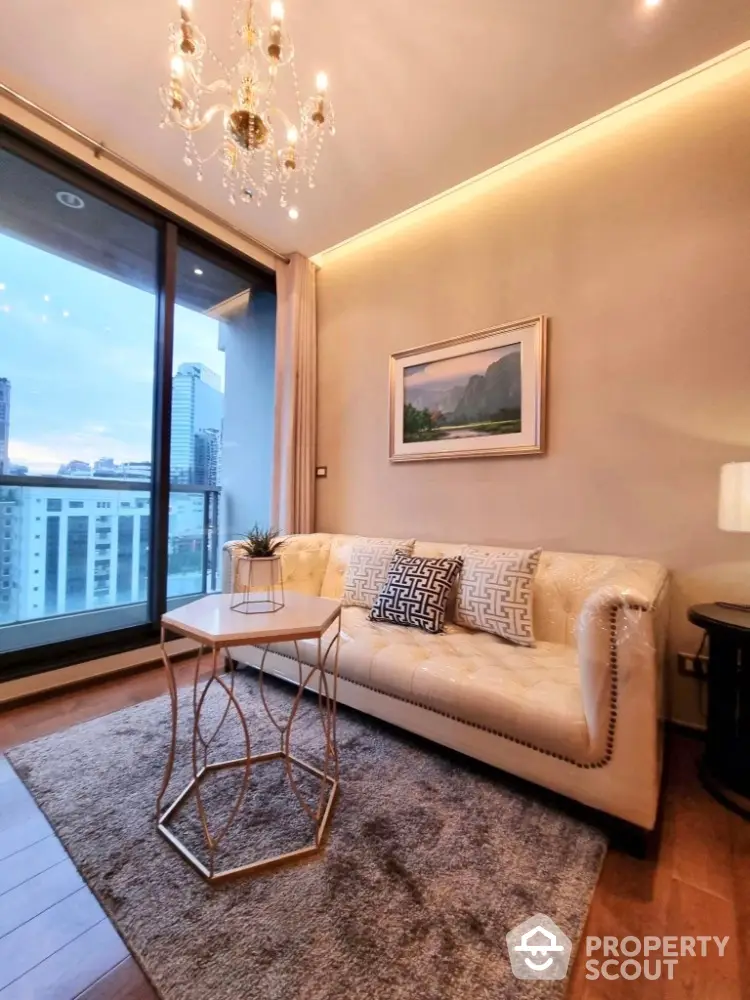 Luxurious living room with elegant chandelier and city view balcony.