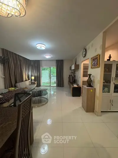 Spacious living room with modern decor and large windows offering natural light.