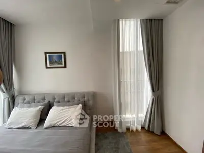 Modern bedroom with stylish decor and large window for natural light