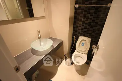 Modern bathroom with glass sink and stylish tile design