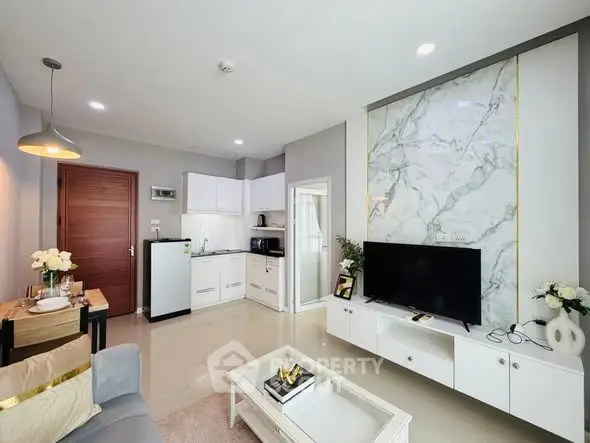 Modern living room with sleek kitchen and marble accent wall, ideal for stylish urban living.