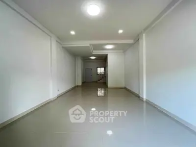 Spacious and modern interior with glossy tiled floors and bright lighting, perfect for versatile living arrangements.