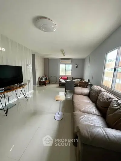 Spacious living room with modern decor and large windows for natural light.