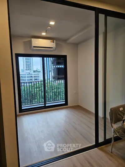 Modern apartment with large windows and balcony view in urban setting