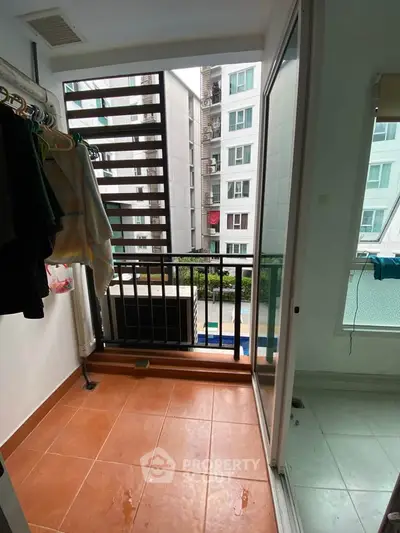 Charming balcony with city view, perfect for relaxation and enjoying fresh air in a modern apartment.