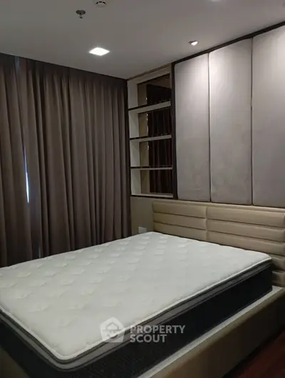 Modern bedroom with stylish padded headboard and elegant curtains