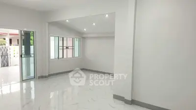 Spacious modern living room with large windows and marble flooring