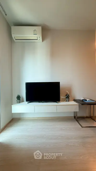 Modern living room with sleek TV setup and air conditioning