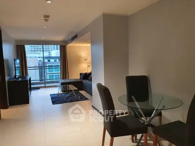 Modern living room with glass dining table and city view balcony in stylish apartment.