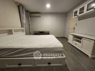 Spacious bedroom with modern furnishings and ample storage space.