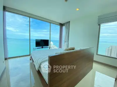 Luxurious bedroom with stunning ocean view and floor-to-ceiling windows