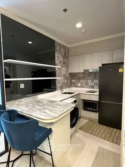 Modern kitchen with marble countertop and stylish backsplash