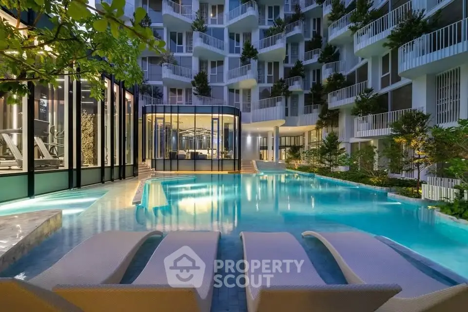 Luxurious modern apartment complex with stunning pool and lush greenery