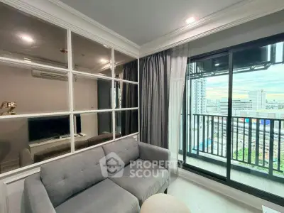 Modern living room with city view and balcony access in high-rise apartment.