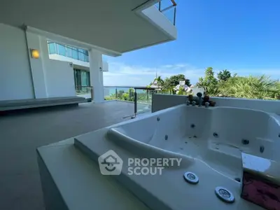 Luxurious balcony with jacuzzi and stunning ocean view in modern property