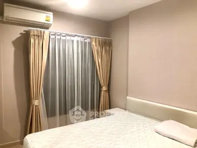Cozy bedroom with elegant curtains and air conditioning unit, perfect for restful nights.